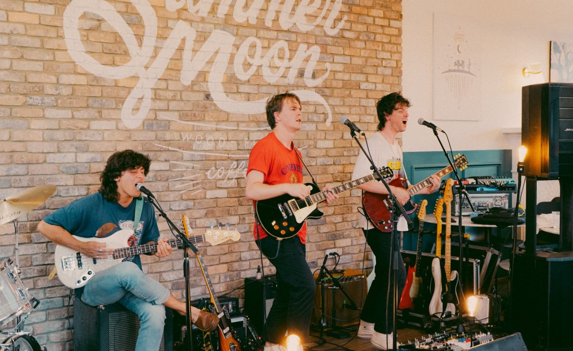Three men playing guitar and singing