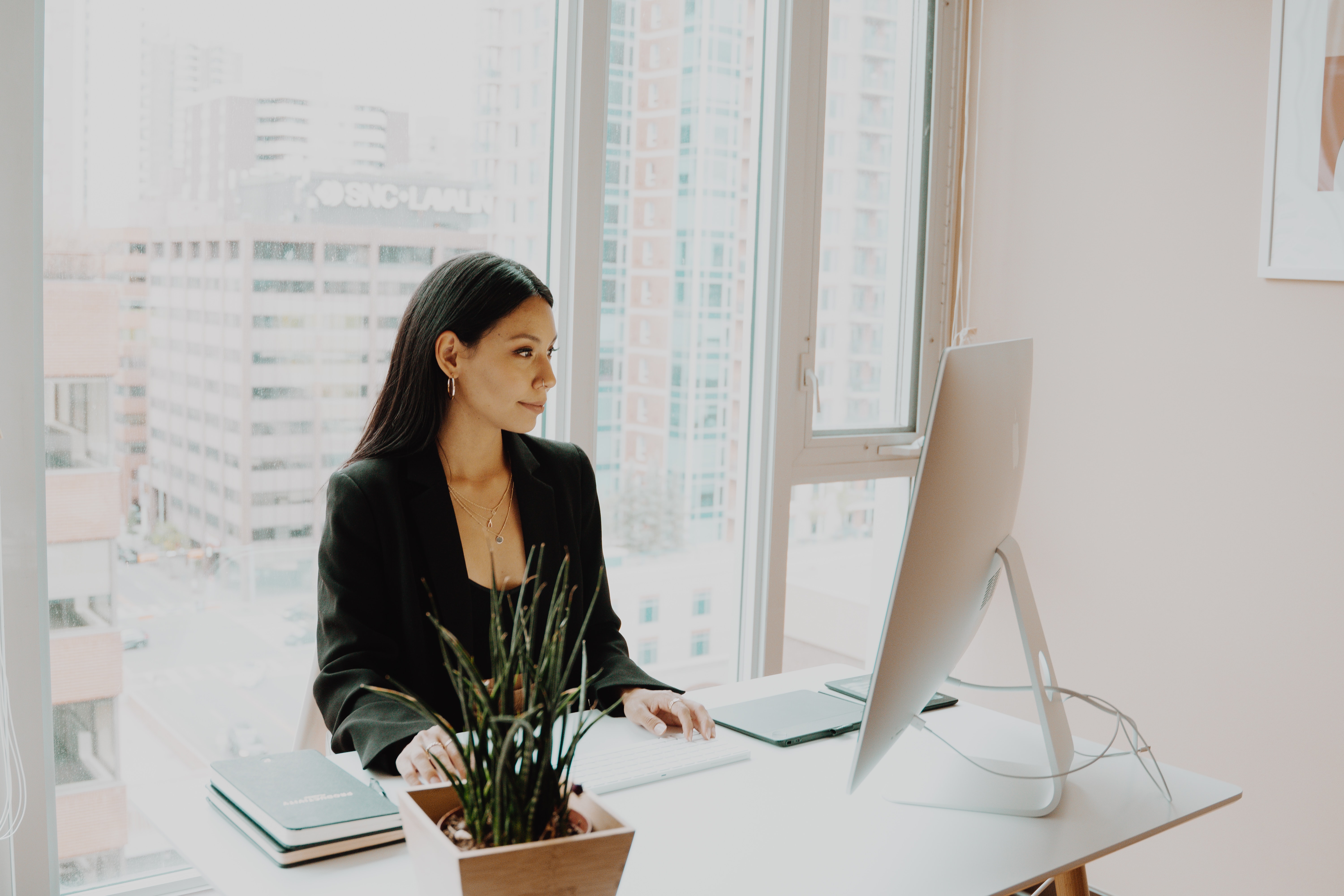 A woman typing, to receive Access to Capital for Women in Business